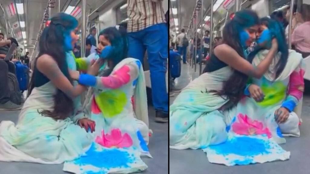 two girls playing Holi in metro