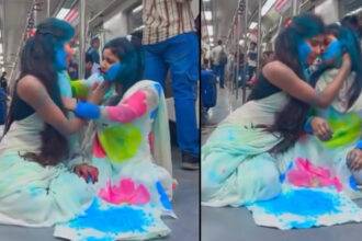 two girls playing Holi in metro